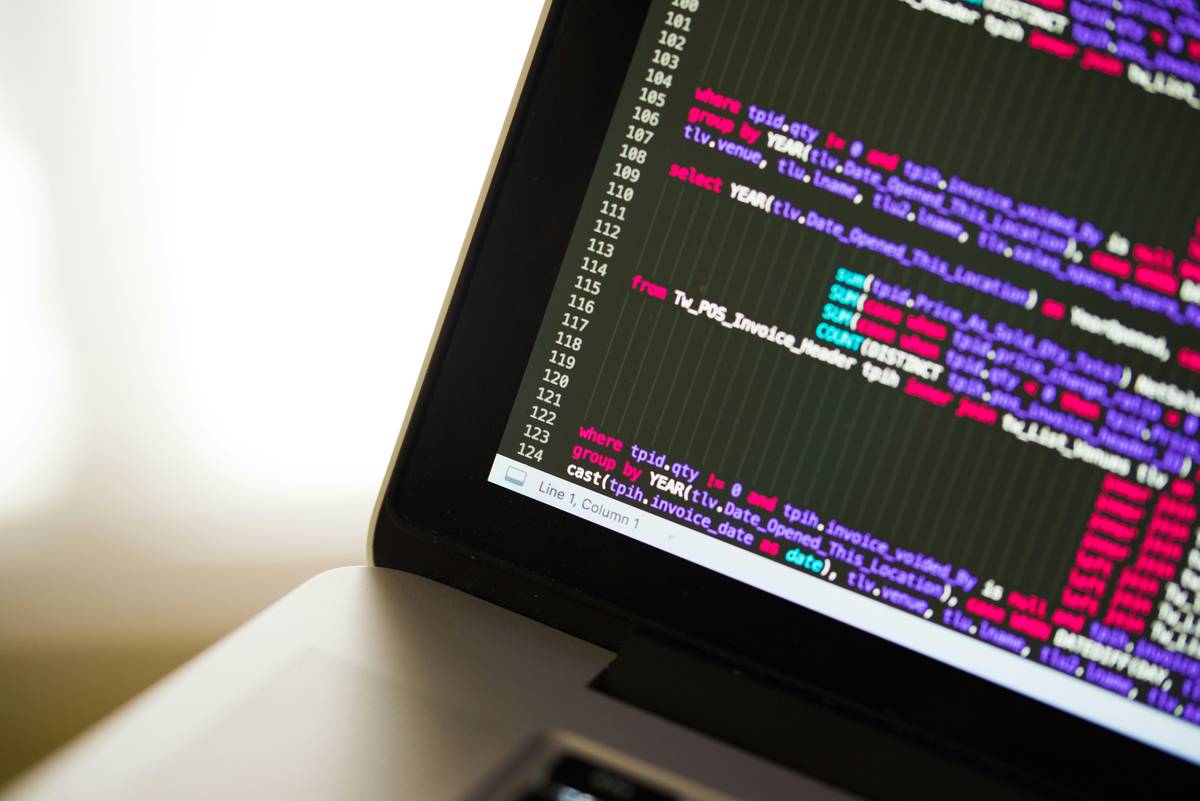 software development smart contract how to: developer reviewing Ethereum Solidity code on dual monitors